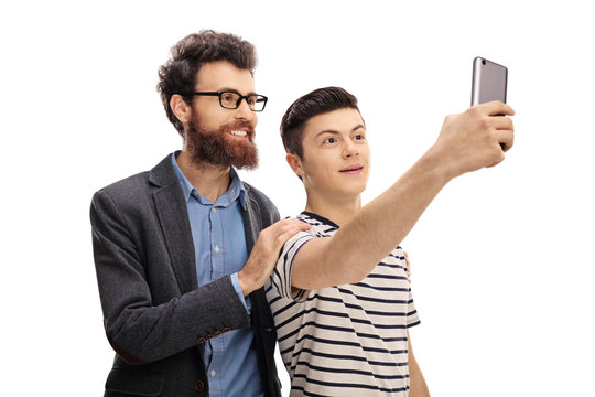 Young man and a teenage boy taking a selfie together