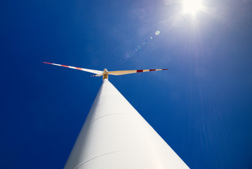 Windrad Gegenlichtaufnahme mit Lens flares und tiefblauem Himmel