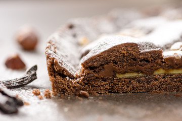 Chocolate Tart Pie Topped with Hazelnuts and Sprinkled with Powdered Sugar