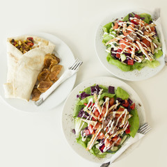 Tortilla and two delicious salads served on a table
