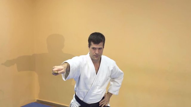 Aikido technique demonstration to students. Man doing aikido.