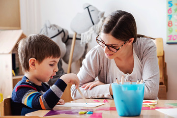 Teacher and Child Playing And Learning at Classroom
