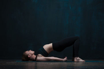 Fototapeta na wymiar Young healthy woman practicing yoga ondoors