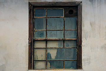 Windows and exterior wall of an old abandoned house