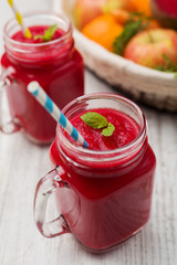 Vegetable and fruit cocktail, served in a jar, with fresh beets, carrots and apples.