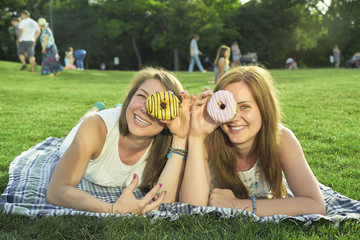 two friends lying on the lawn