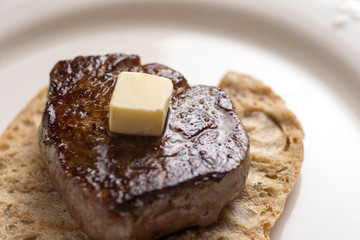 Beef Steak Fillet on Toasted Baguette Bread with Melting Butter and Herbs