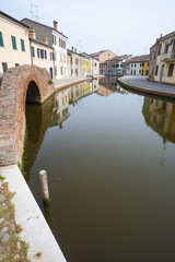 View of the small Italian town Comacchio (Ferrara, Emilia Romagna region): traditional colored...