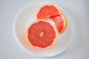 Obraz na płótnie Canvas High angle view of Pink grapefruit half and slices
