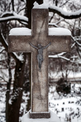 Christian cross covered with snow