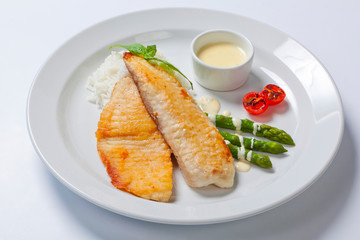 delicious fish steak with green asparagus and rice