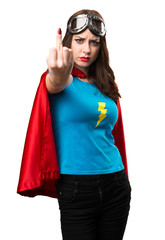 Pretty superhero girl making horn gesture