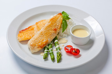 delicious fish steak with green asparagus and rice