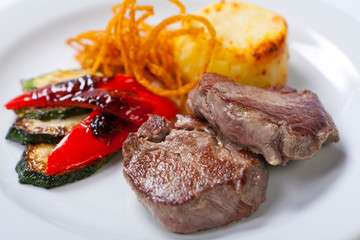 fried pork steaks with potatoes, peppers and zucchini