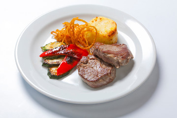 fried pork steaks with potatoes, peppers and zucchini