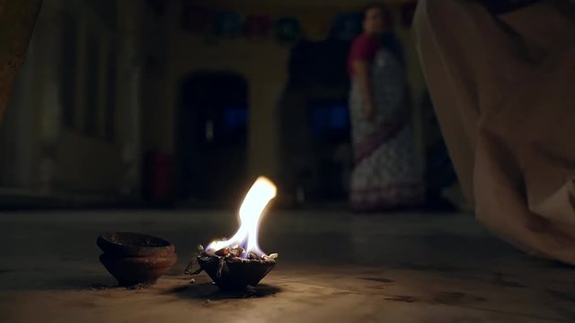 moment of prayer in the temple of Krishna with oily candle and bathed in fire