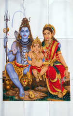 Fototapeta premium Colorful illustration of Hindu goddess Shiva with Annapurna and Ganesha on the wall in Kolkata, India 