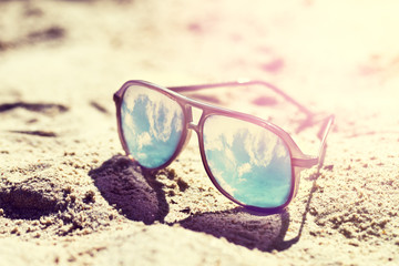 Summer or Vacation Concept. Beautiful Sunglasses on Sand. Beach. Lifestyle. Toning.
