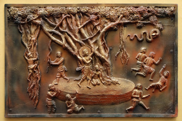 Prince Vardhmanas courage tested by a jealous god who assumes the form of a cobra, Street bass relief on the wall of Jain Temple in Kolkata