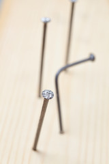 nails on the wood panel