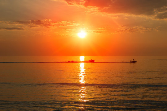 Sunrise and sea landscape, silhouette people activities at sea