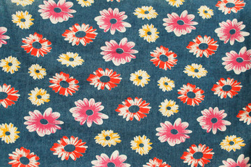 Denim floral background. Jeans background with flowers. Denim seamless pattern. Blue jeans cloth.