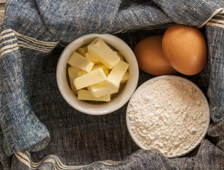 Fototapeta na wymiar Baking ingredients, flour, butter,eggs in a rustic style