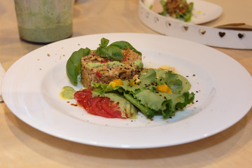 Vegetal Burger in White Dish with Basil, Tomatoes and Lettuce