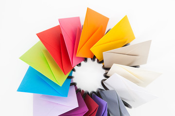 Propeller of colored envelopes on the white desk