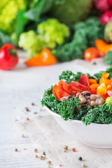 Healthy vegan buddha bowl with kale leaves and raw vegetables