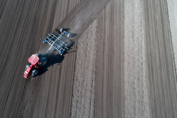 Tractor harrowing soil