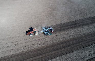 Tractor harrowing soil
