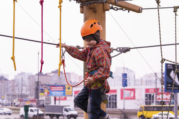 A boy in a helmet on a rope road