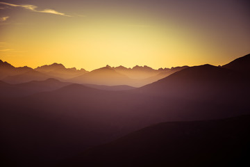 A beautiful, colorful, abstract mountain landscape in a mystic purple and orange tonality. Decorative, artistic look.