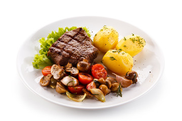 Roast steak with potatoes on white plate