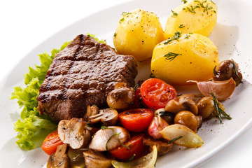 Roast steak with potatoes on white plate
