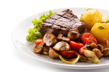 Roast steak with potatoes on white plate