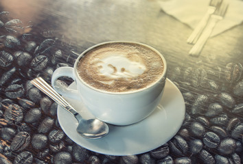 Latte art with coffee bean on wood table (Double exposure technic)