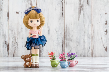 Decorative Cute Doll on White Wooden Background