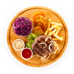 Steaks, baked potatoes and vegetable salad