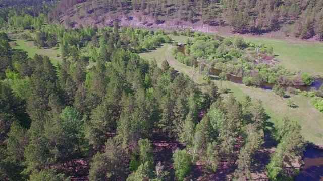 4K. Prores codec. Aerial video from the air. Summer forest with a small mountain river