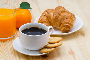 delicious breakfast with fresh croissants on wooden table