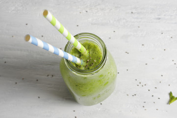 Green smoothie in a glass bottle
