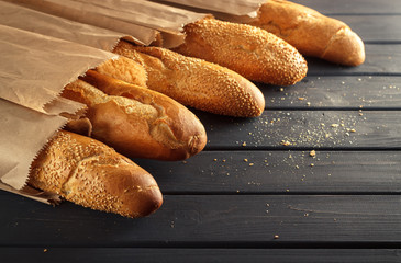 French baguettes with sesame seed on black wooden background