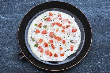 South Indian breakfast Oothappam / Dosa cooked using rice, lentil and vegetables served with coconut chutney and sambhar. popular dish in Kerala and Tamil Nadu India.