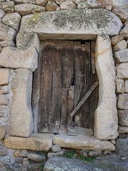 Rustic wooden door on old stone house