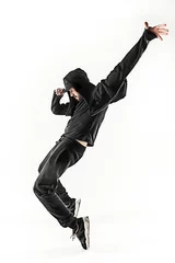 Gardinen The silhouette of one hip hop male break dancer dancing on white background © master1305