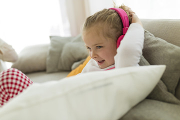 Child listening to music at home.