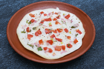 South Indian breakfast Oothappam / Dosa cooked using rice, lentil and vegetables served with coconut chutney and sambhar. popular dish in Kerala and Tamil Nadu India.