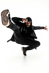 The silhouette of one hip hop male break dancer dancing on white background